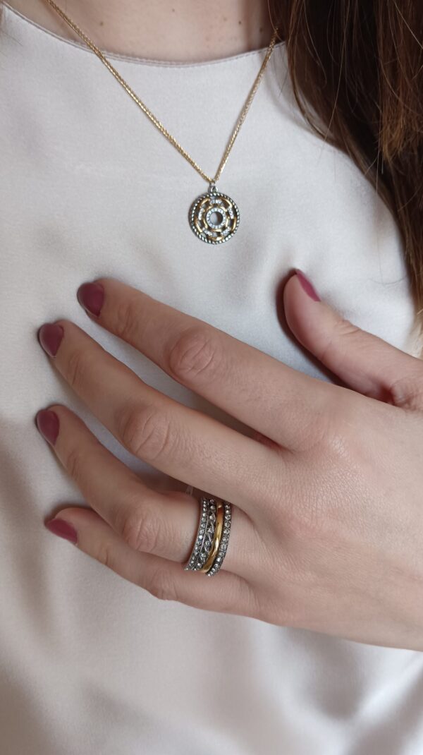 Anel em aço prateado escurecido e dourado, com duas fileiras de zirconias